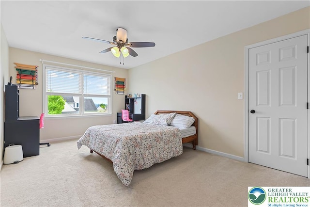 carpeted bedroom with baseboards and ceiling fan