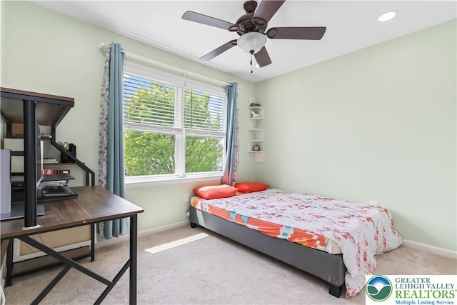 carpeted bedroom featuring baseboards and ceiling fan