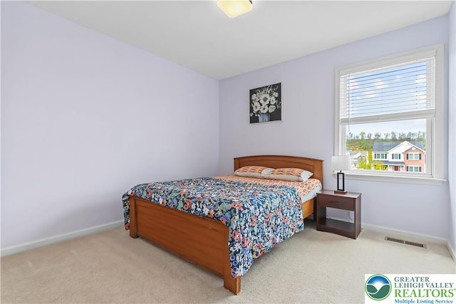bedroom with baseboards, carpet, and visible vents