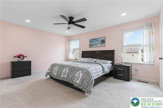 bedroom with light colored carpet, recessed lighting, baseboards, a ceiling fan, and visible vents