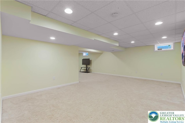 basement featuring carpet floors, recessed lighting, baseboards, and a paneled ceiling