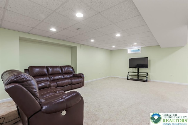 living area featuring carpet floors, baseboards, recessed lighting, and a paneled ceiling