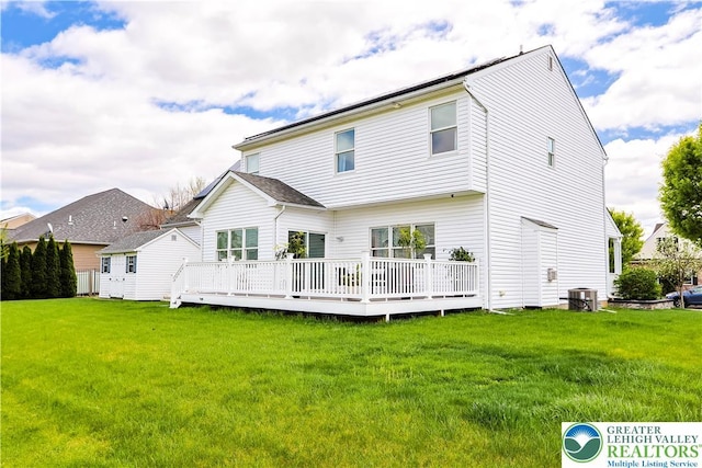 back of house with a yard, a wooden deck, and central AC unit