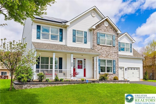 view of front of property with covered porch, solar panels, stone siding, and aphalt driveway