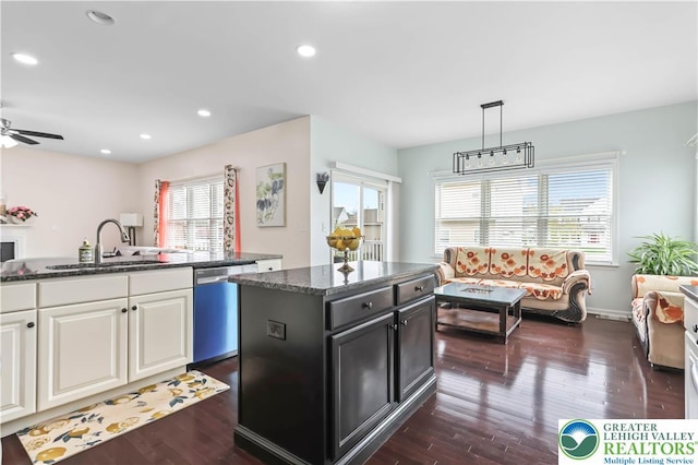 kitchen with a ceiling fan, a center island, dark wood-type flooring, a sink, and dishwasher