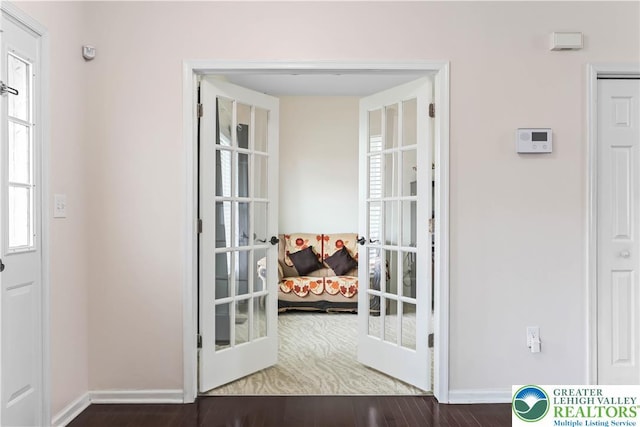 doorway to outside with baseboards, french doors, and wood finished floors