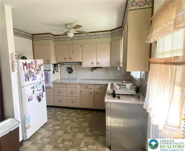 kitchen featuring light countertops, ceiling fan, and white appliances