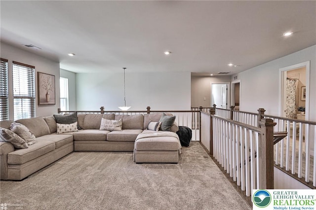 carpeted living area with recessed lighting and visible vents