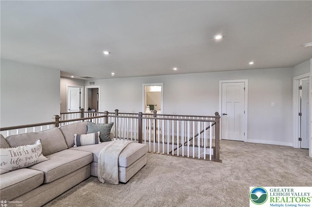 carpeted living room with recessed lighting and visible vents