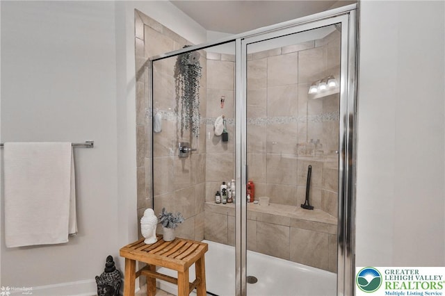 full bath with baseboards and a stall shower