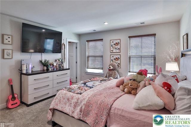 carpeted bedroom featuring baseboards, multiple windows, and visible vents