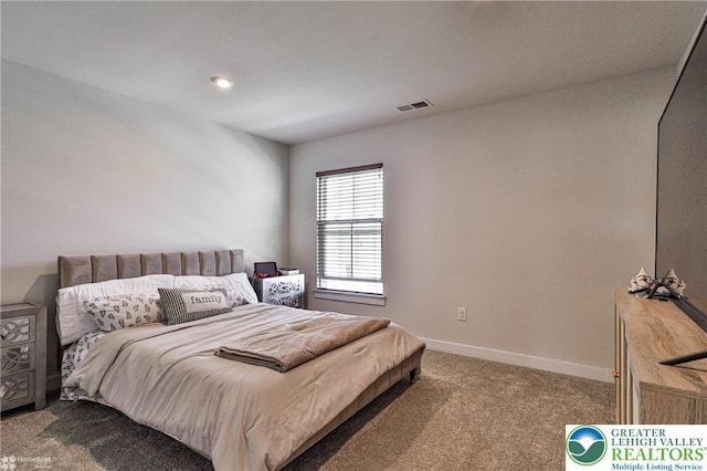 carpeted bedroom featuring baseboards and visible vents