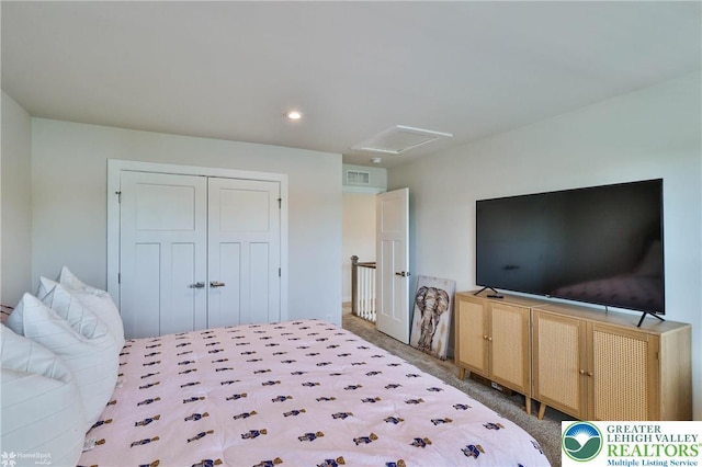 carpeted bedroom featuring recessed lighting, a closet, attic access, and visible vents