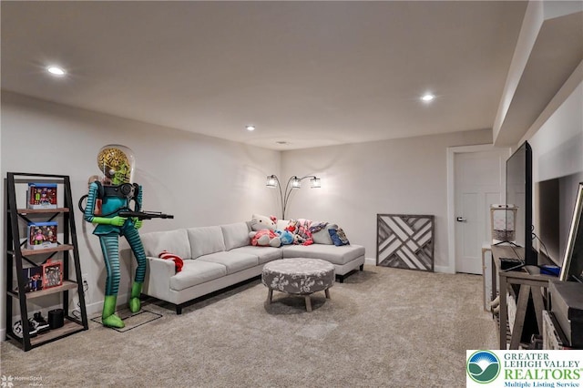 carpeted living area with recessed lighting and baseboards