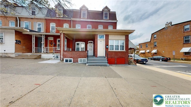 858 N 7th St, Allentown City, PA 18102 - townhome / multi-family property with brick siding and covered porch
