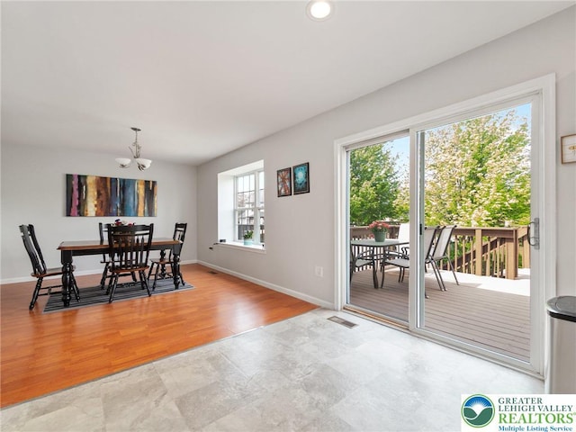 dining area with baseboards, visible vents, recessed lighting, and a notable chandelier