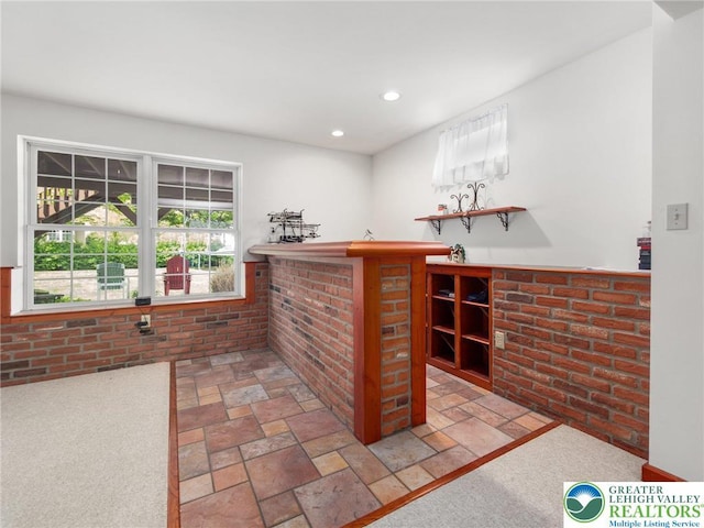 bar featuring stone tile floors, recessed lighting, and a dry bar