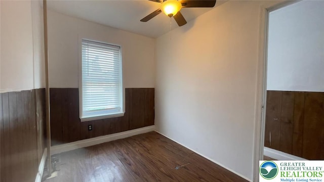 1541 W Tilghman St, Allentown City, PA 18102 - spare room with wooden walls, a wainscoted wall, a ceiling fan, and wood finished floors