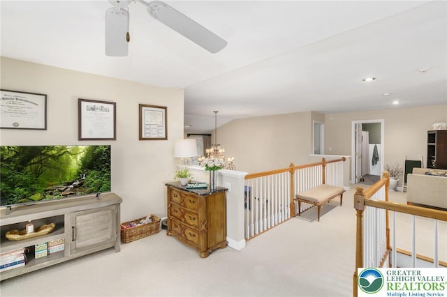 corridor featuring a notable chandelier, carpet flooring, recessed lighting, and an upstairs landing