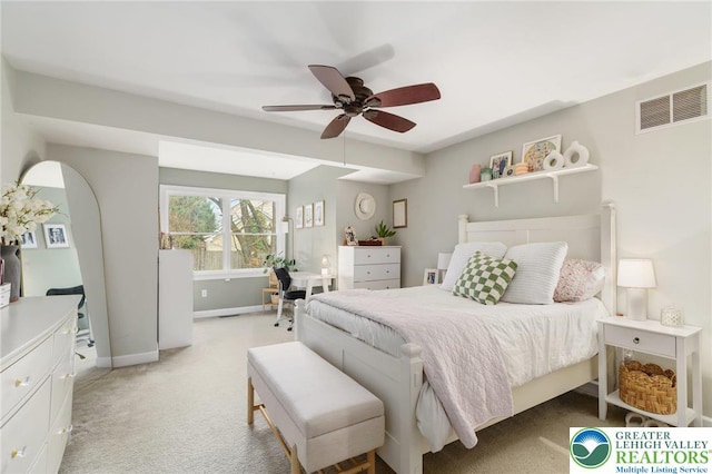 bedroom featuring light colored carpet, baseboards, visible vents, and a ceiling fan