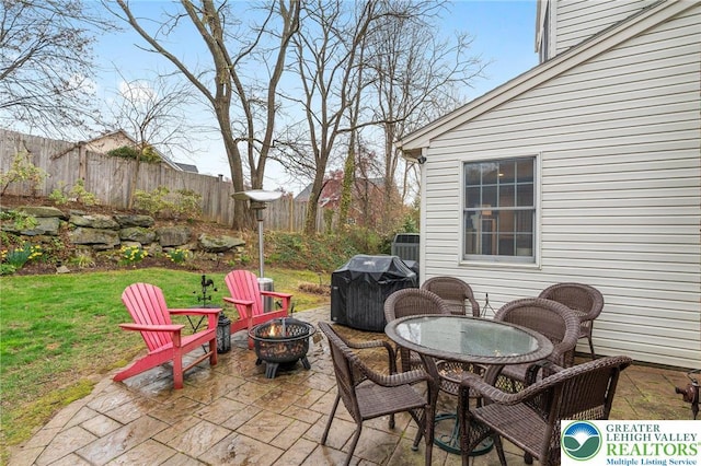 view of patio / terrace featuring a fire pit, fence, and grilling area