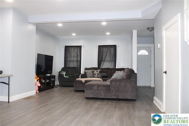living room with recessed lighting, baseboards, and light wood-style floors