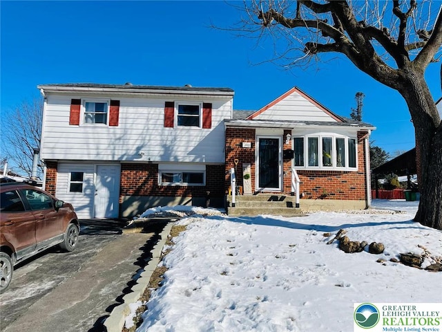split level home with brick siding