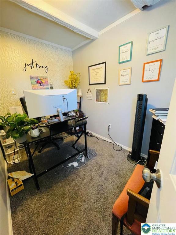 office space with carpet flooring, baseboards, and beam ceiling