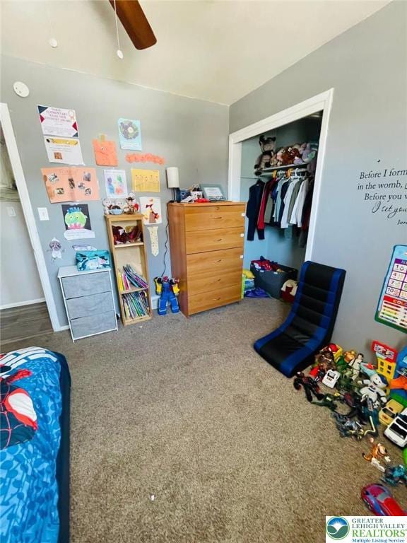 playroom with a ceiling fan and carpet