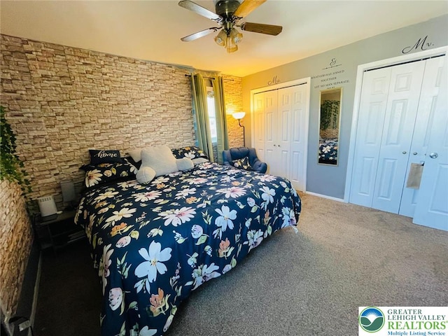 carpeted bedroom with ceiling fan and multiple closets