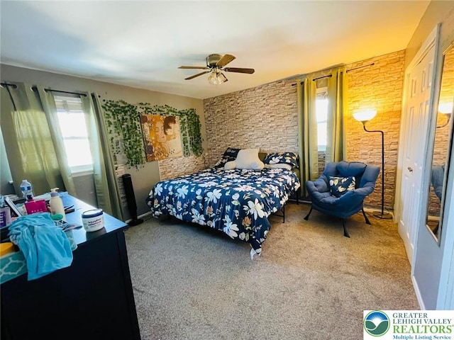 carpeted bedroom featuring multiple windows and ceiling fan