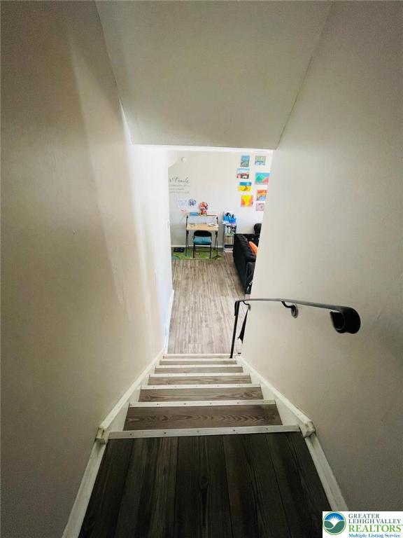 stairway featuring wood finished floors