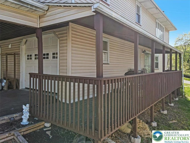 view of side of home with a garage and driveway