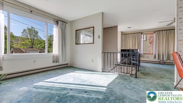 unfurnished room with carpet flooring, baseboards, and a baseboard heating unit