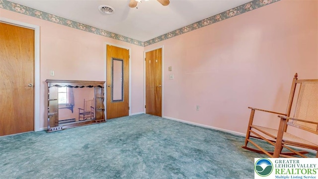 unfurnished room featuring carpet flooring, a ceiling fan, baseboards, and visible vents