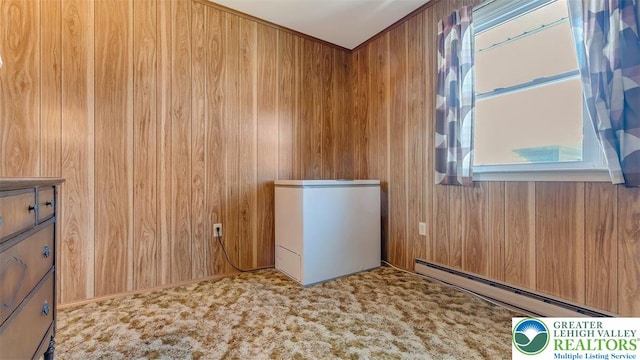 interior space featuring a baseboard radiator and wooden walls