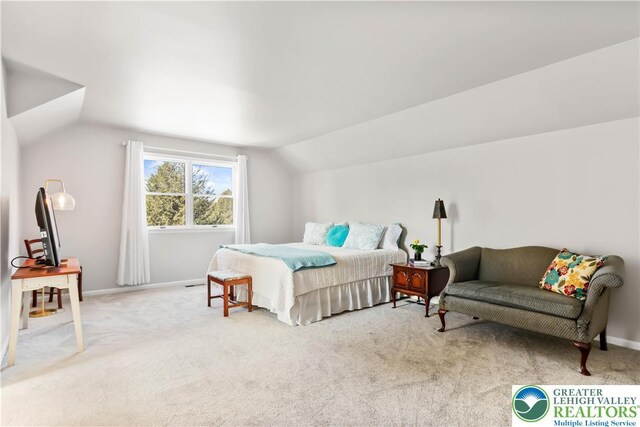 bedroom with baseboards, light colored carpet, and lofted ceiling