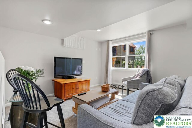 living area featuring baseboards, light carpet, and recessed lighting