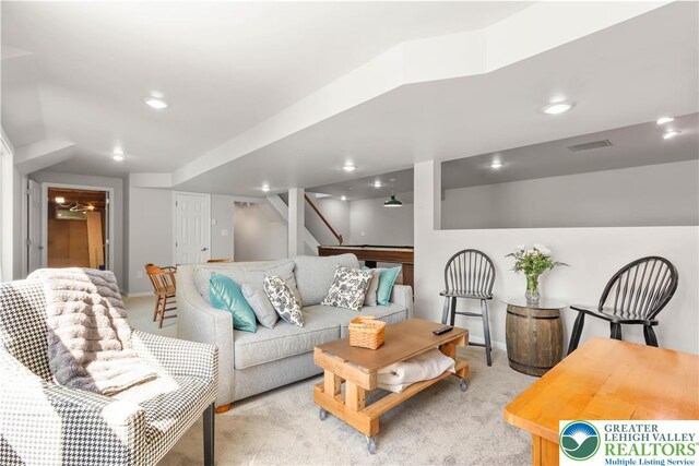living room with recessed lighting, baseboards, visible vents, and light carpet