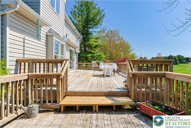 wooden deck featuring outdoor dining space