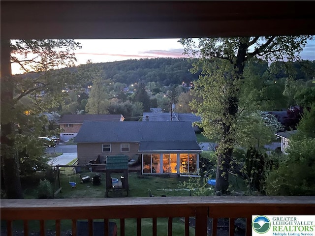 rear view of property with a forest view