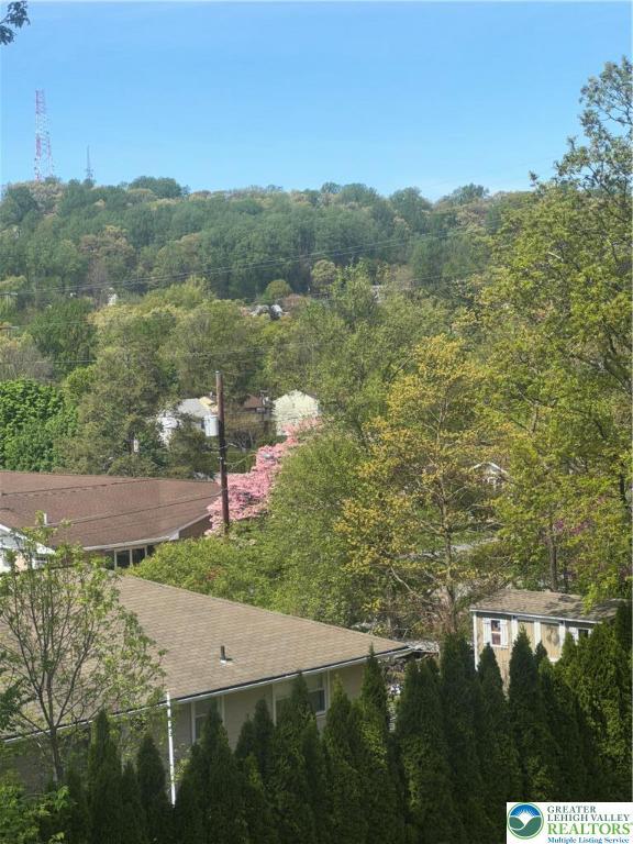 drone / aerial view featuring a forest view