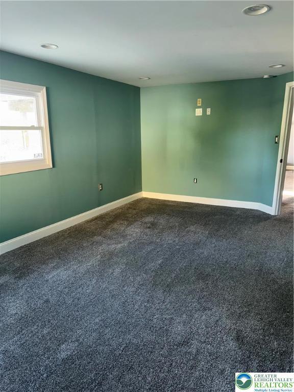 carpeted empty room featuring recessed lighting and baseboards
