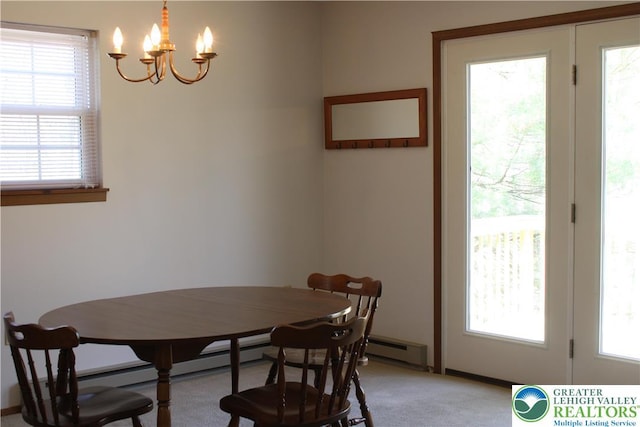 95 Piney Woods Dr, Penn Forest Township, PA 18229 - dining space with light colored carpet, an inviting chandelier, and a baseboard radiator