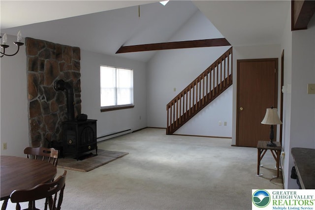 95 Piney Woods Dr, Penn Forest Township, PA 18229 - living room featuring high vaulted ceiling, a baseboard radiator, carpet, and a wood stove