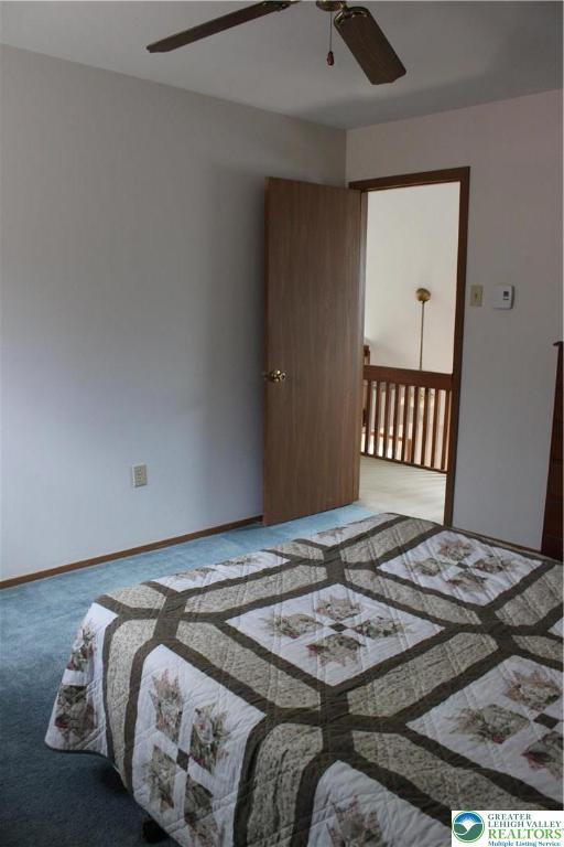 95 Piney Woods Dr, Penn Forest Township, PA 18229 - carpeted bedroom with baseboards and ceiling fan
