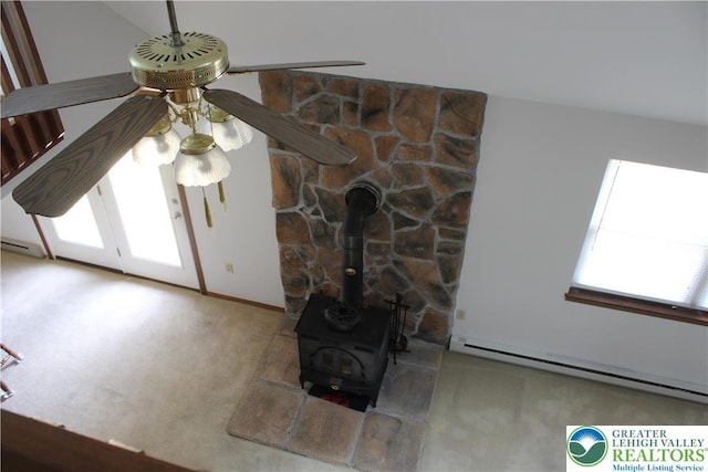 95 Piney Woods Dr, Penn Forest Township, PA 18229 - details with carpet flooring, a wood stove, a ceiling fan, baseboards, and a baseboard heating unit