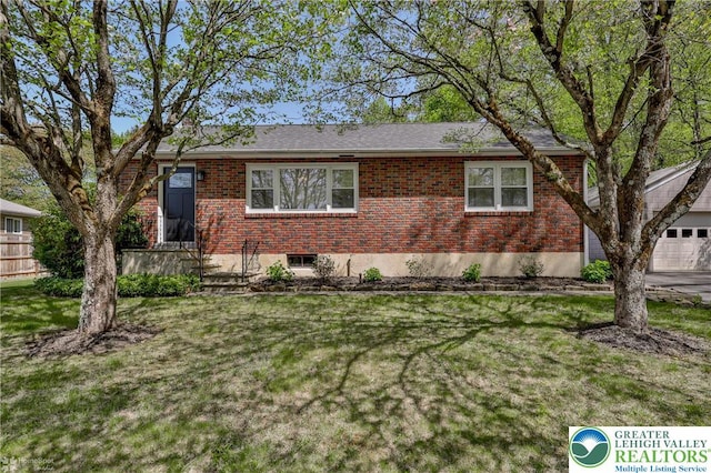 ranch-style home with brick siding, a garage, and a front yard
