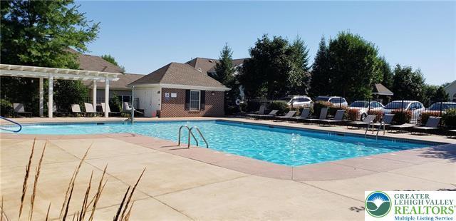 community pool with fence, a patio, and a pergola