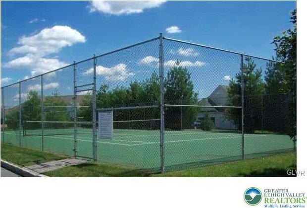 view of tennis court featuring fence